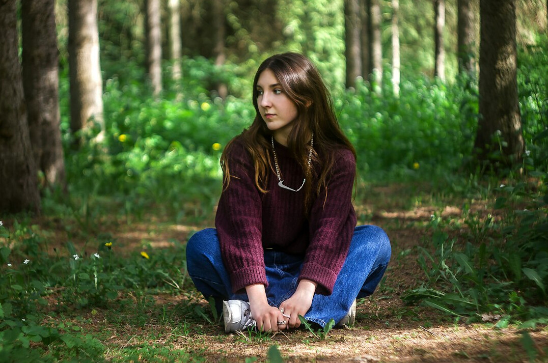 woman meditating in forest