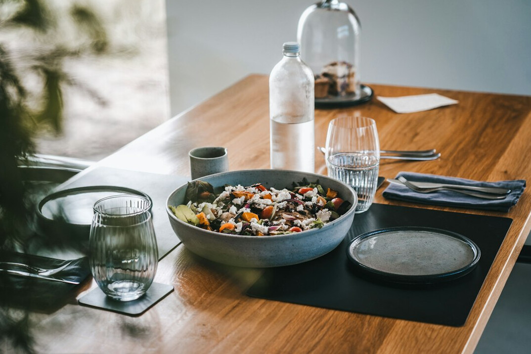 Colorful healthy meal bowls with fresh vegetables on a wooden table